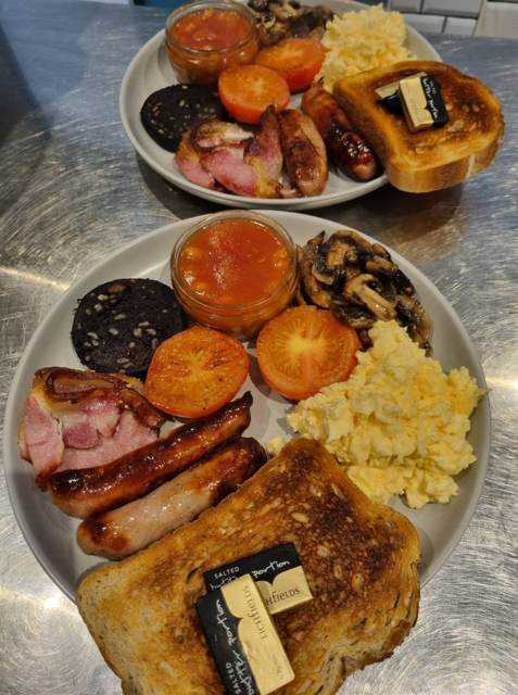 A full English with scrambled eggs, sausages, bacon, black pudding, mushrooms, tomatoes and beans