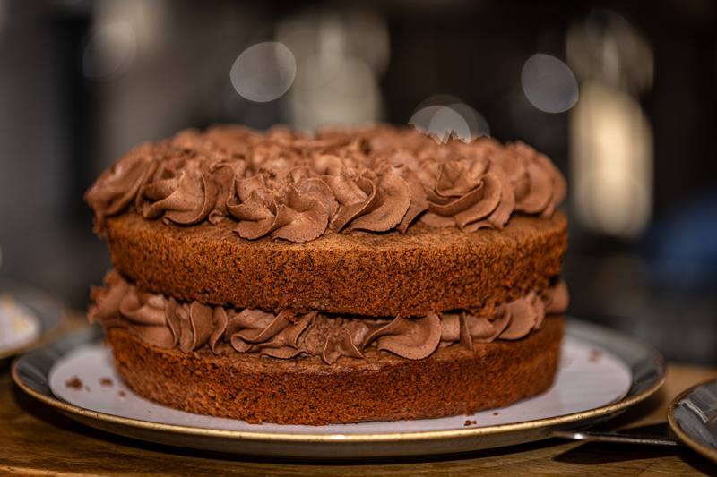 A two-layer chocolate cake with swirls of chocolate buttercream